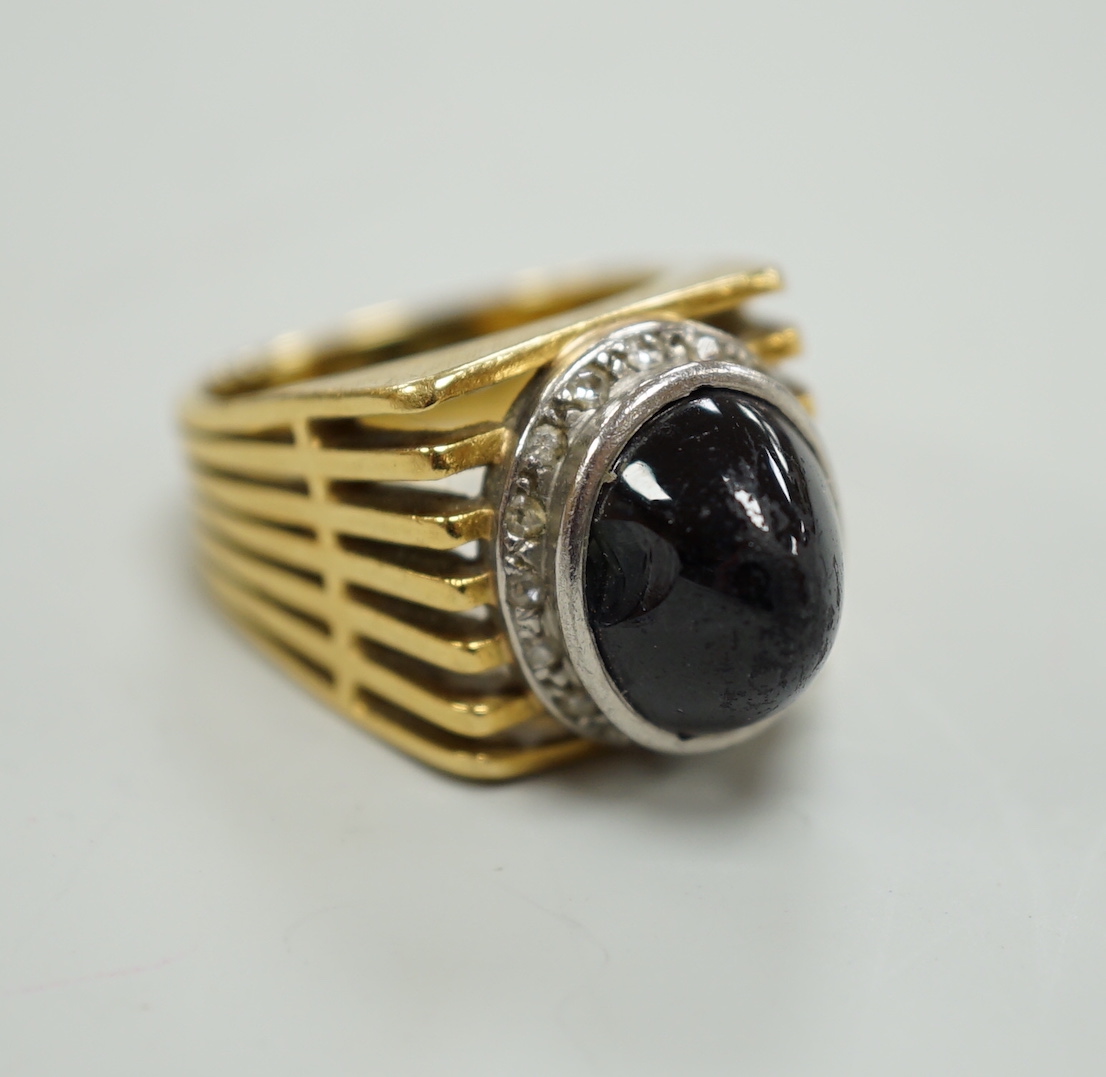 A pierced yellow metal, cabochon sapphire and diamond chip cluster set dress ring, size M, gross weight 13.4 grams.